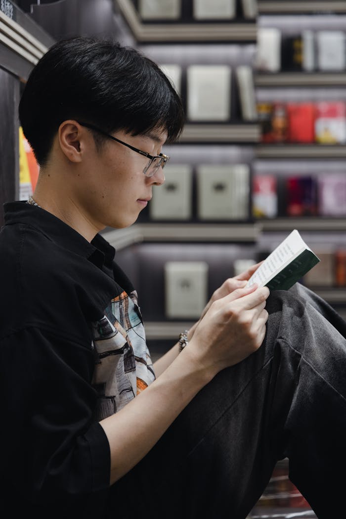 A young man engrossed in reading at a bookstore in Huaian, China.