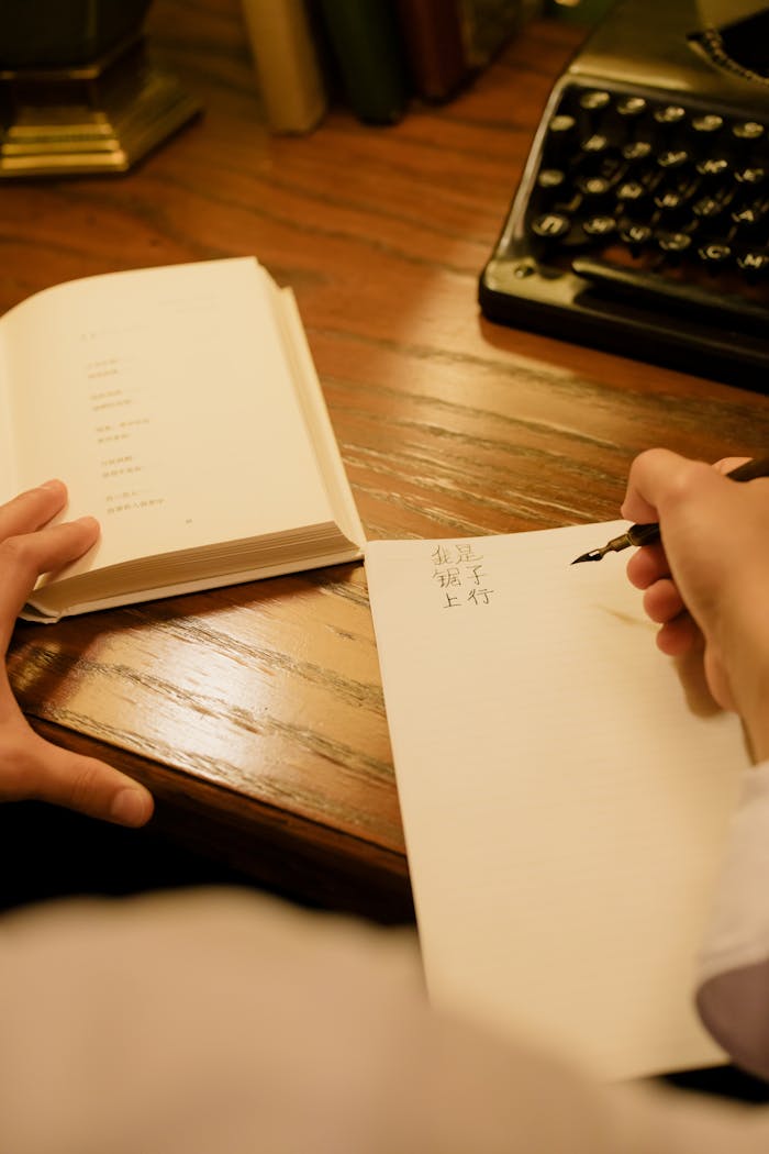 A nostalgic vintage writing setup with a typewriter and calligraphy practice on a wooden desk.